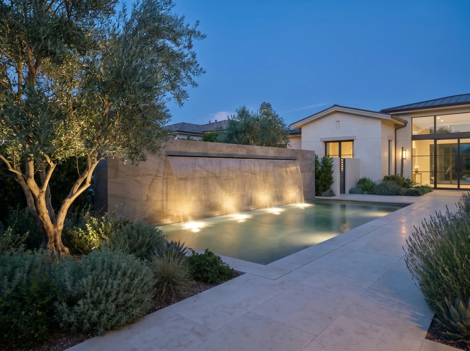 Sculptural water feature and stone focal point integrated into the garden